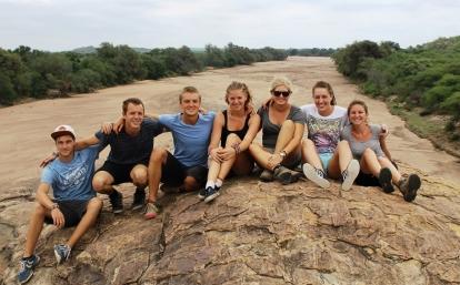 Conservation group volunteer work in Botswana Projects Abroad wildlife conservation volunteering group in Botswana sitting on top of a hill